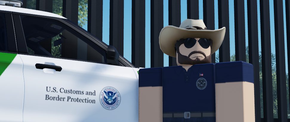 An officer beside an agency vehicle.